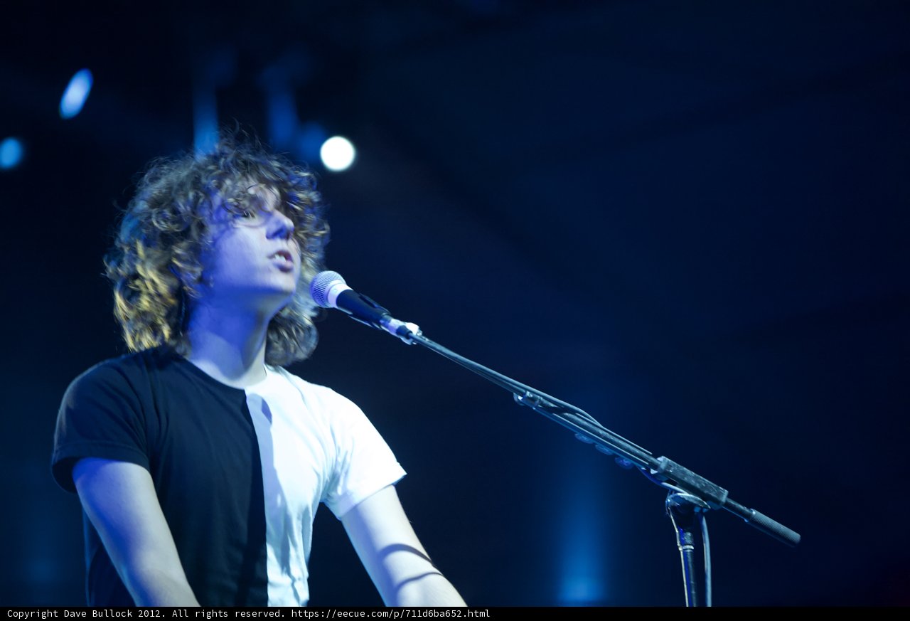 Man with curly hair rocks the stage