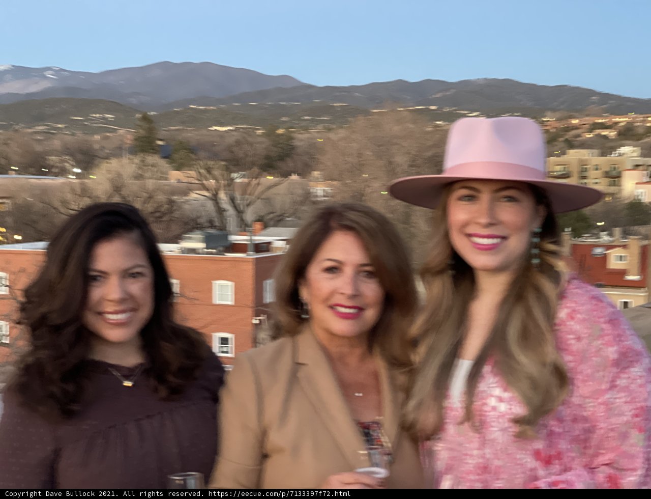Women in Hats with a Mountainous Backdrop