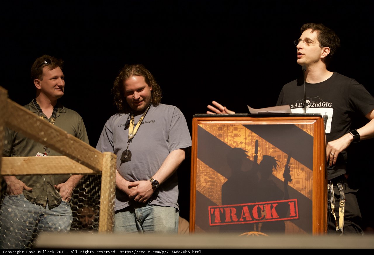 Three Men Address the Crowd from Behind a Podium