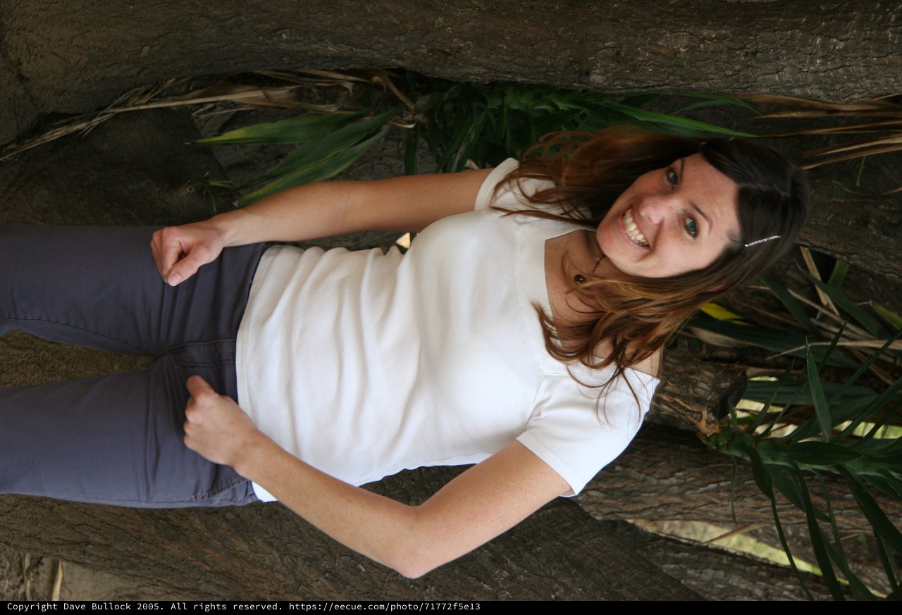 Smiling Woman Posing Between Tropical Trees
