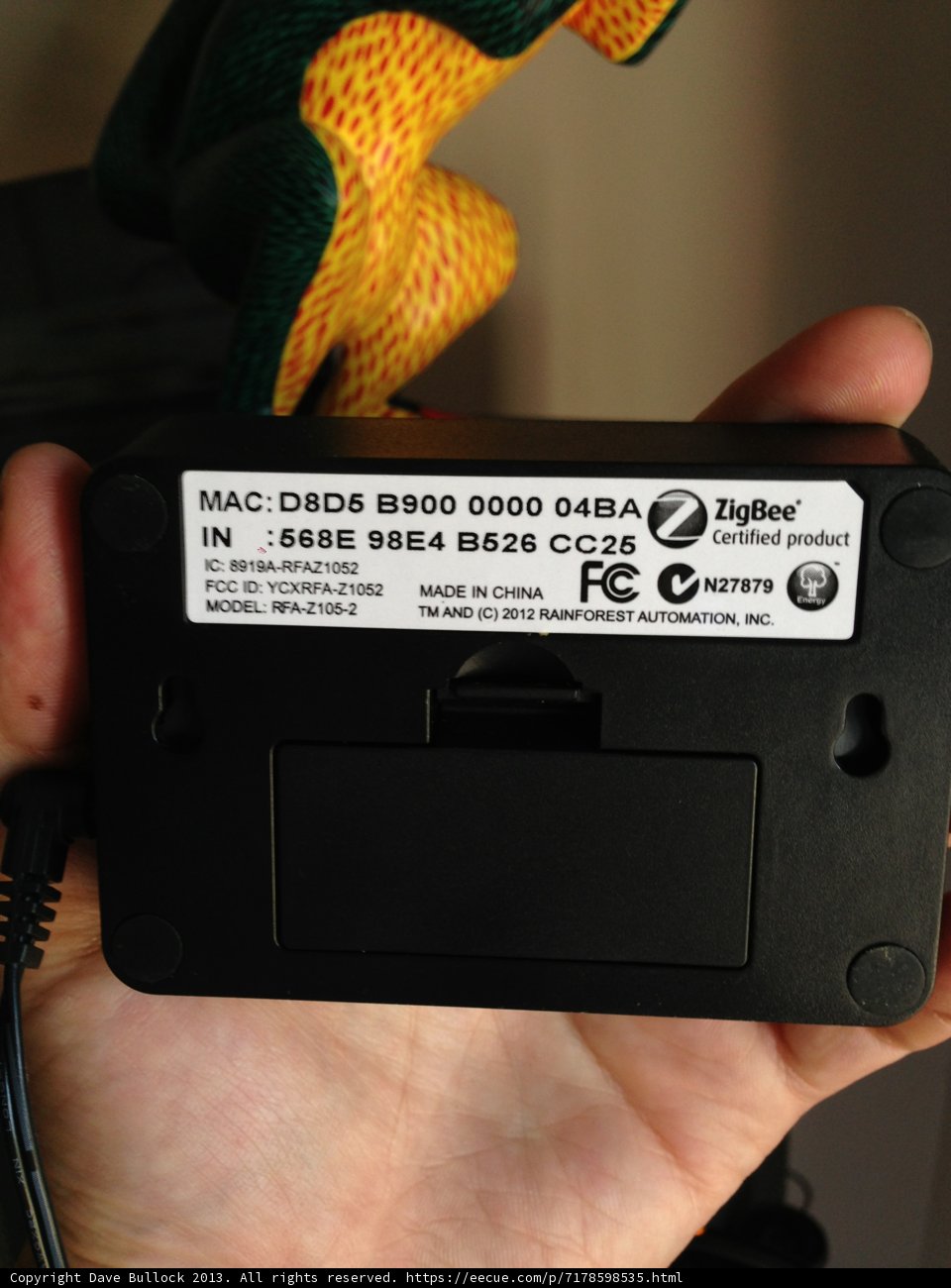 Adapter at Hand Caption: A person holds a small electronic device, possibly an adapter, in Altadena, California.