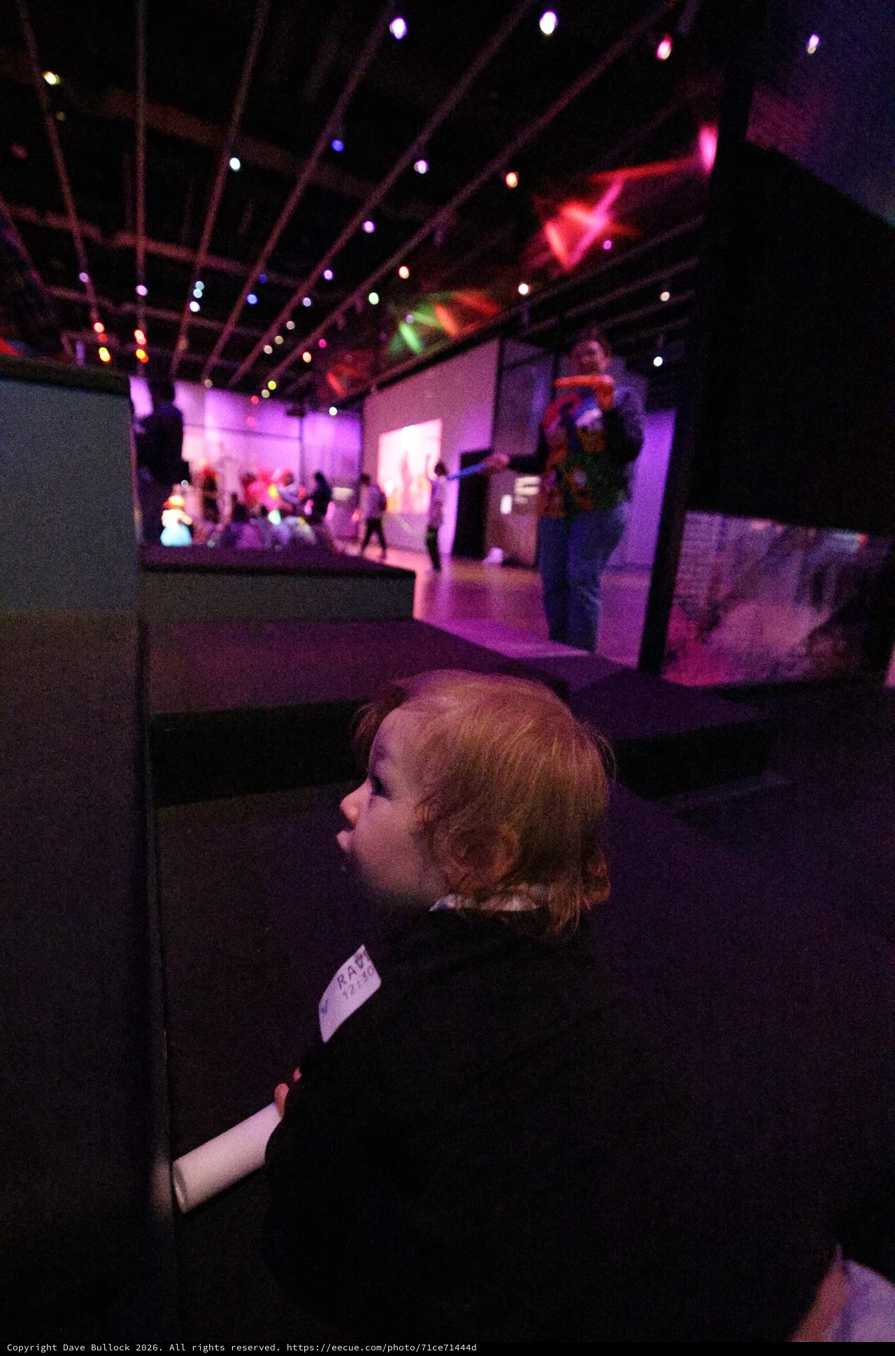Child Mesmerized by Colorful Baby Rave Light Display