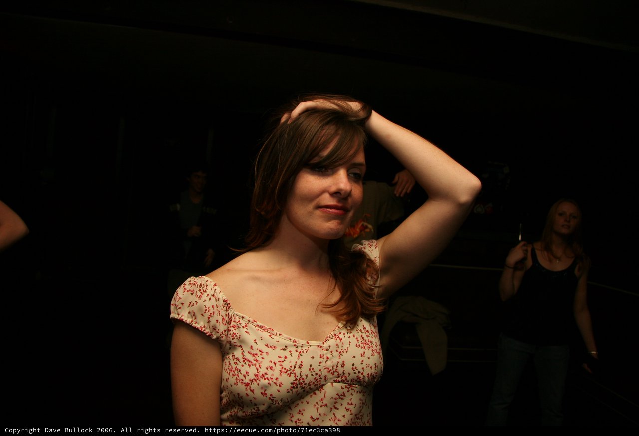 Young Woman Dancing at Dimly Lit Venue