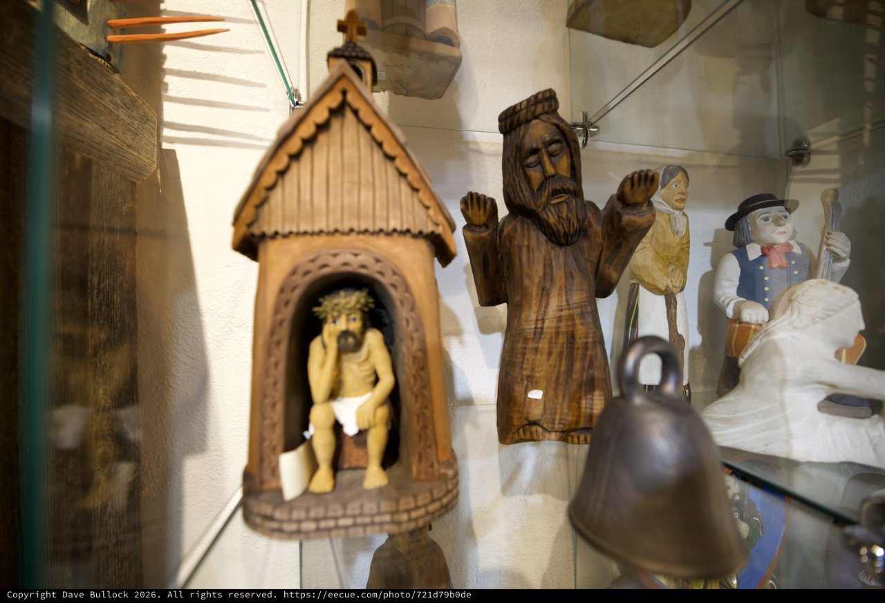 Collection of Folk Art and Religious Wood Carvings Display