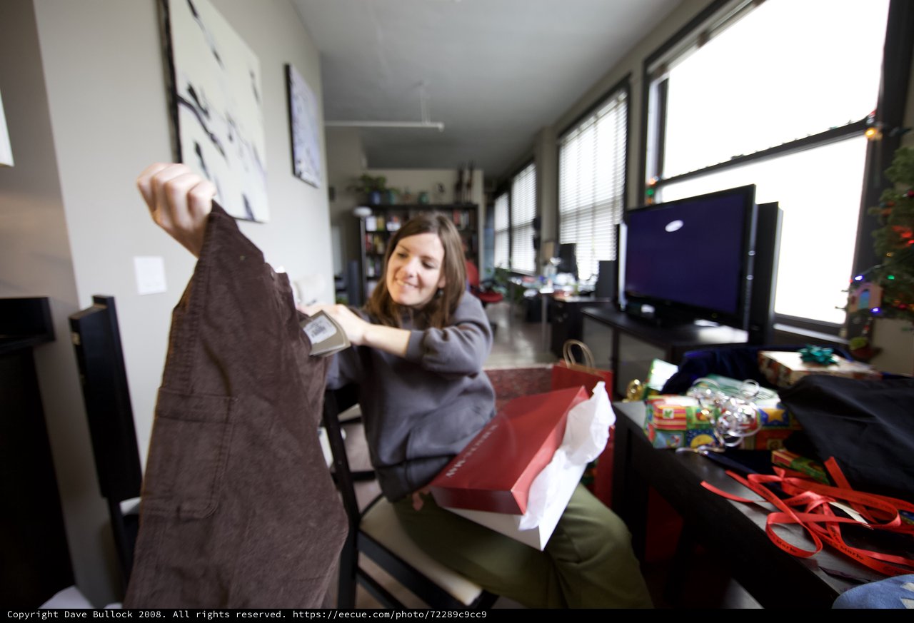 Joyful Christmas Gift Unwrapping in Modern Apartment