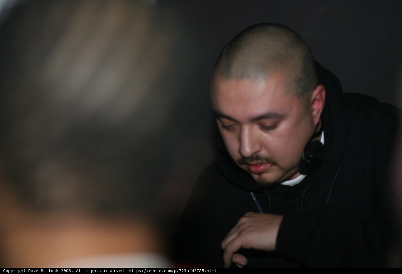 Bald-headed man dons black jacket