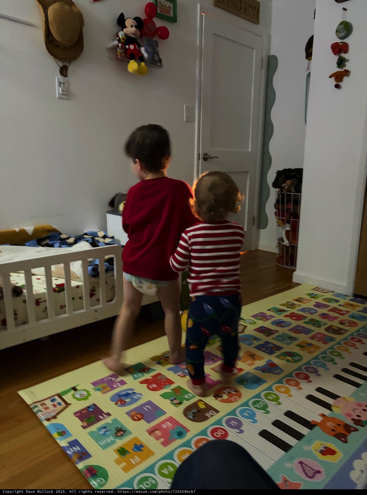 Two Young Children Playing in Colorful Bedroom
