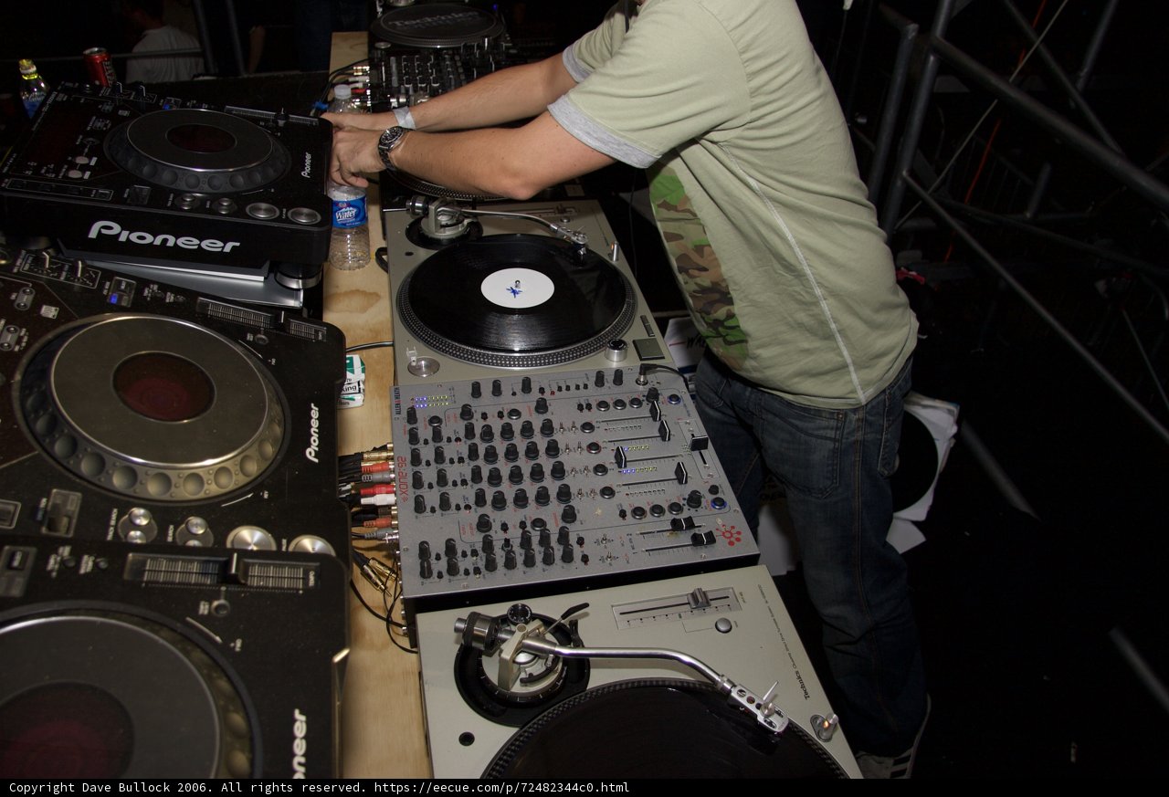 Green-Shirted DJ Entertaining the Crowd