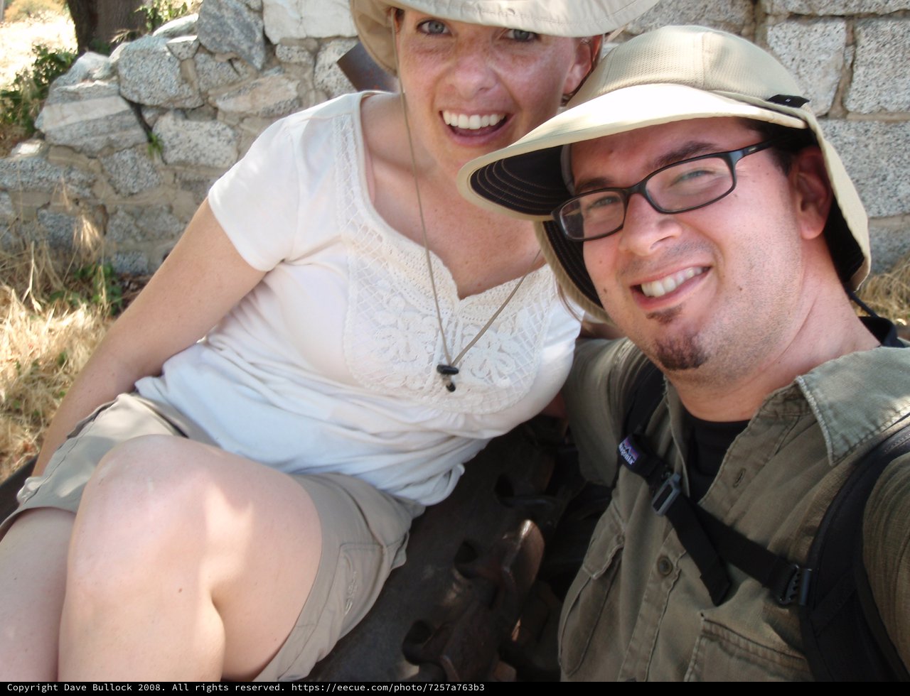 Two Smiling Travelers Posing at Ancient Ruins