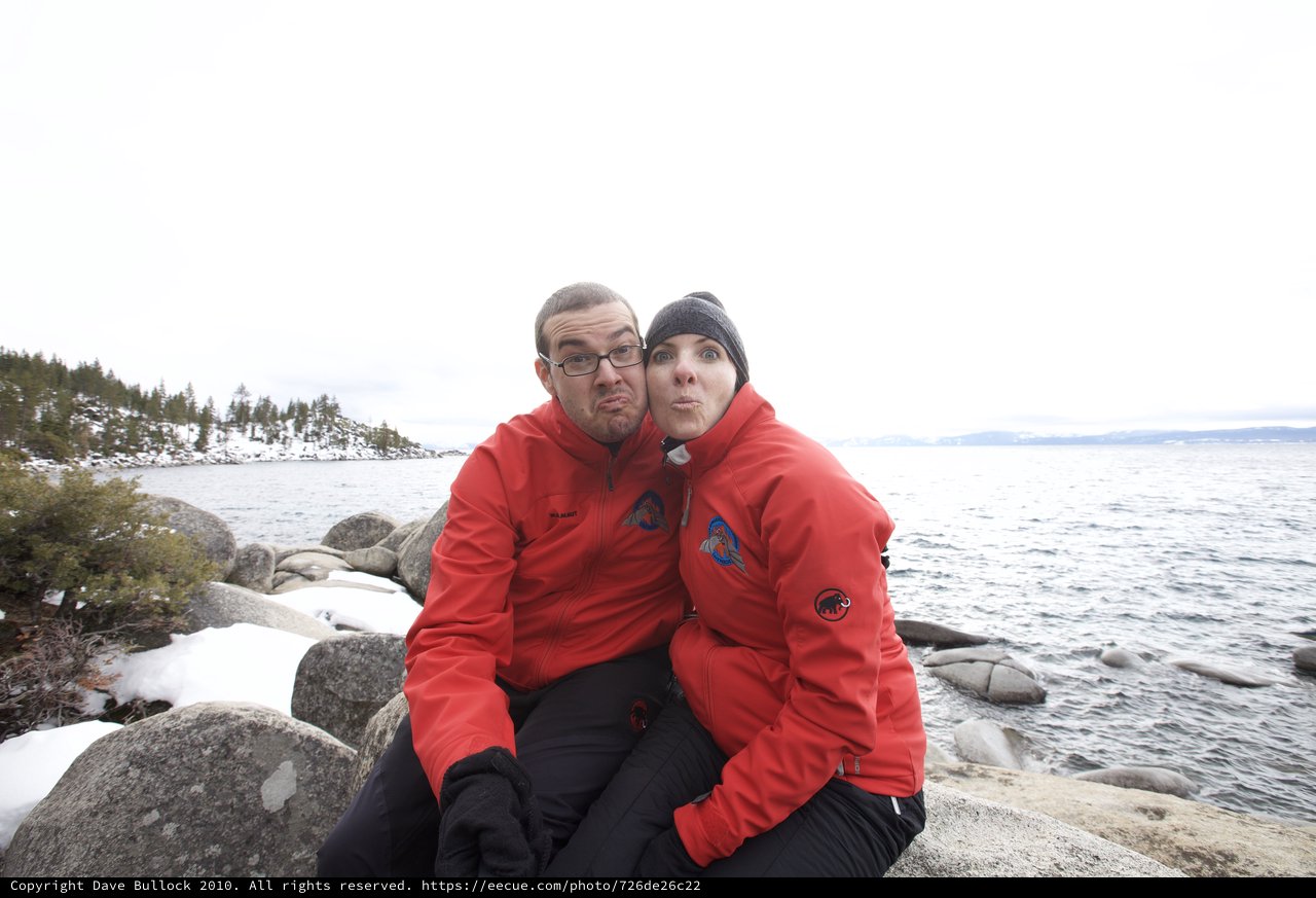 Couple Makes Silly Faces at Snowy Lake Tahoe Shore