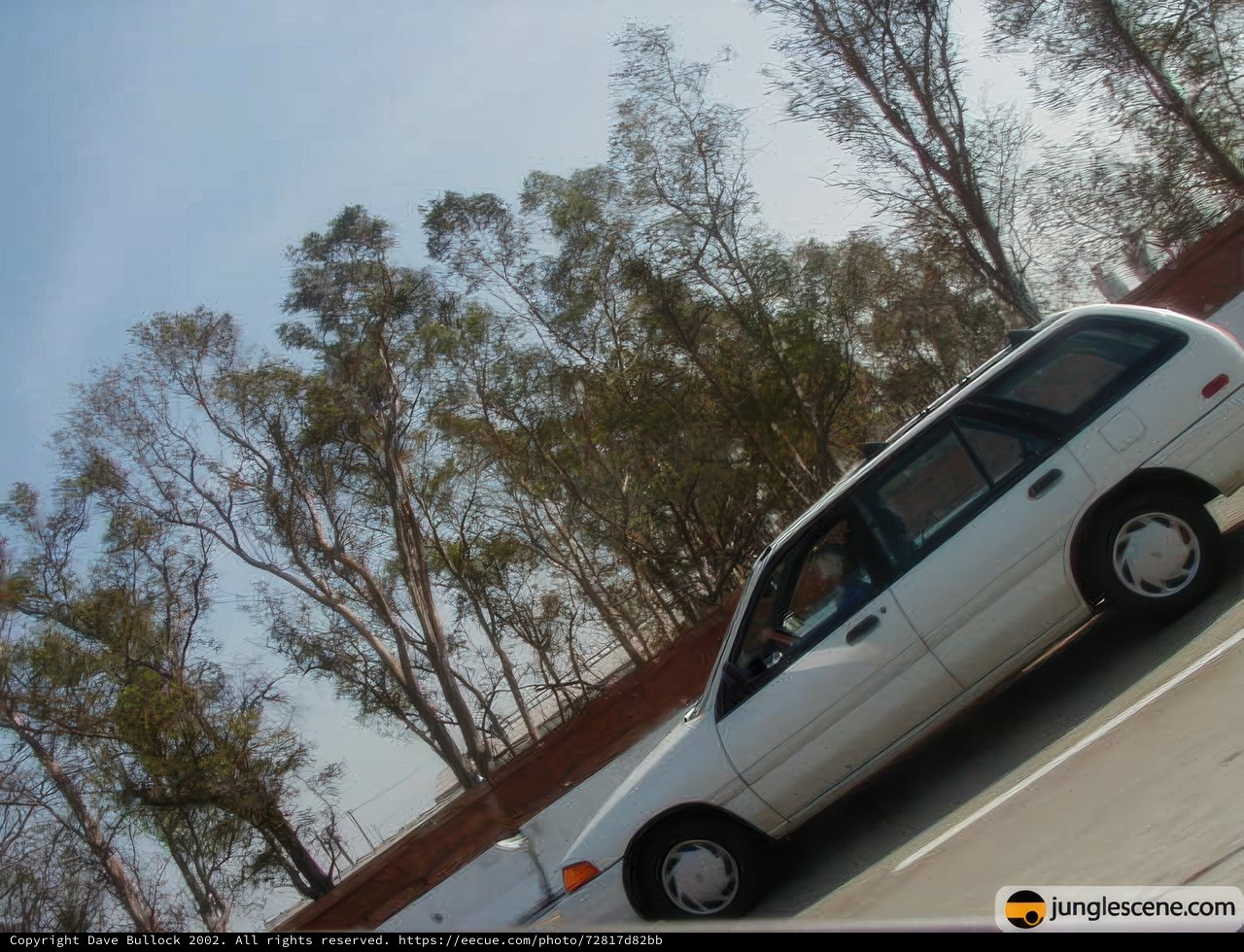 White Car Cruising on Open Road