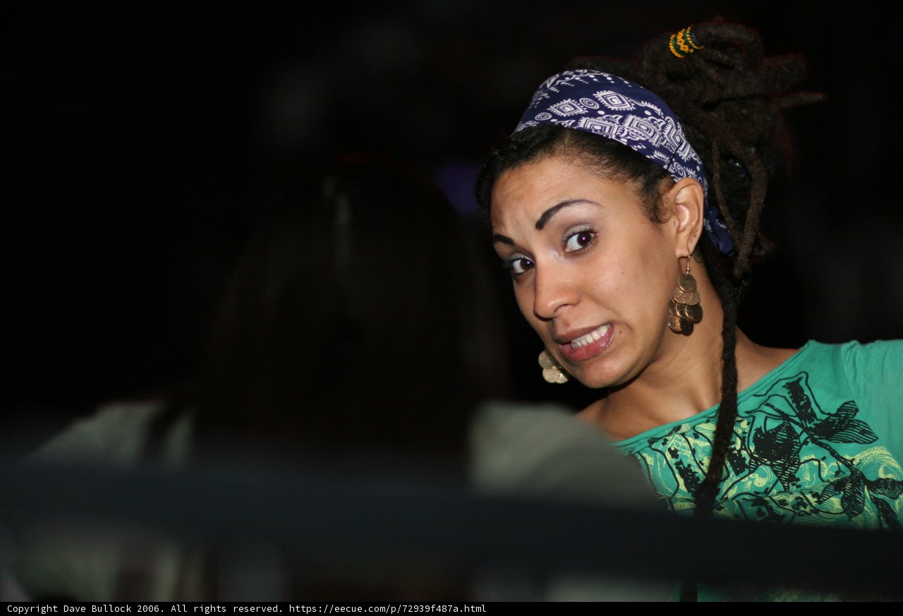 Smiling Woman with Dreadlocks in Green Shirt