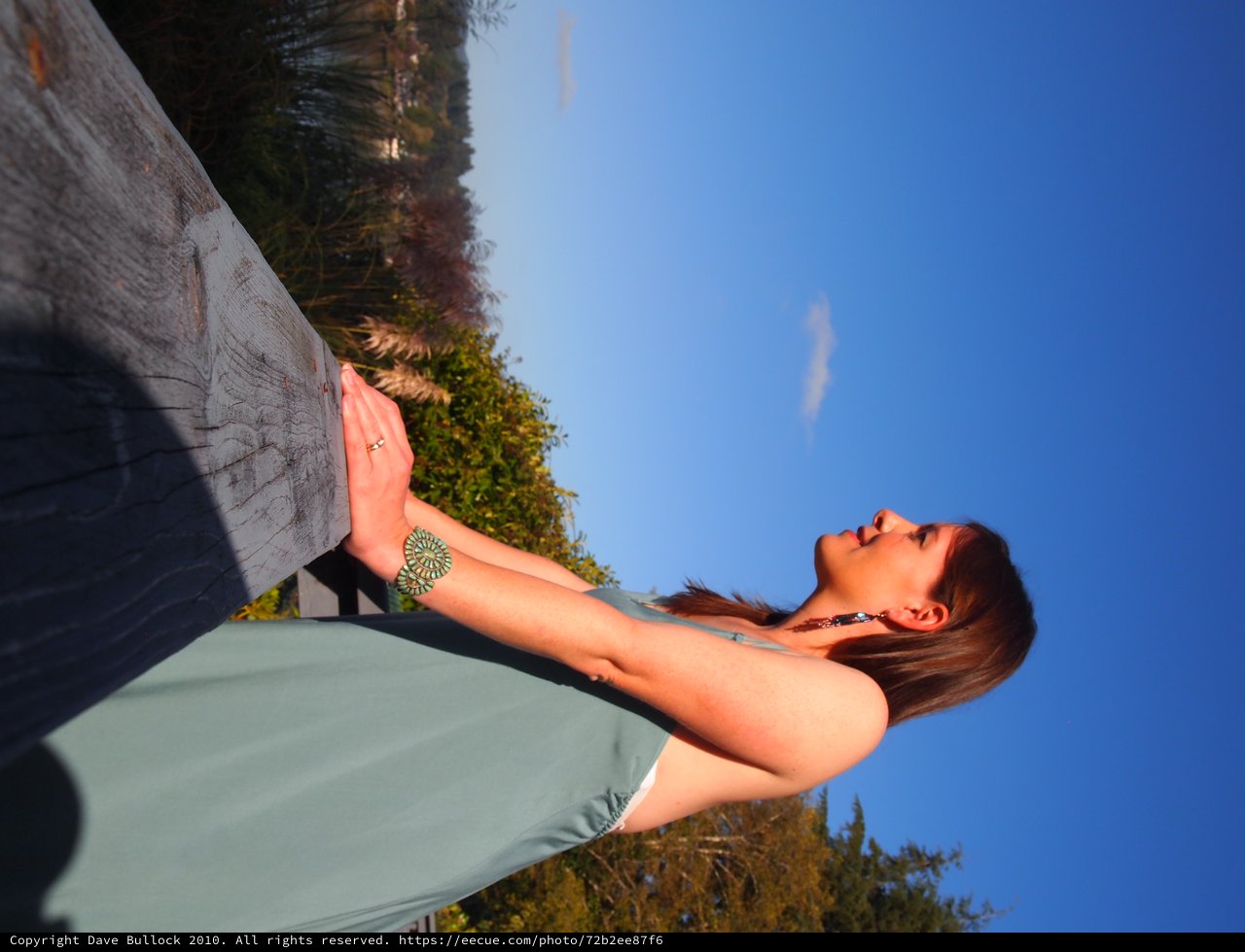 Serene Woman in Prayer Pose at Golden Hour