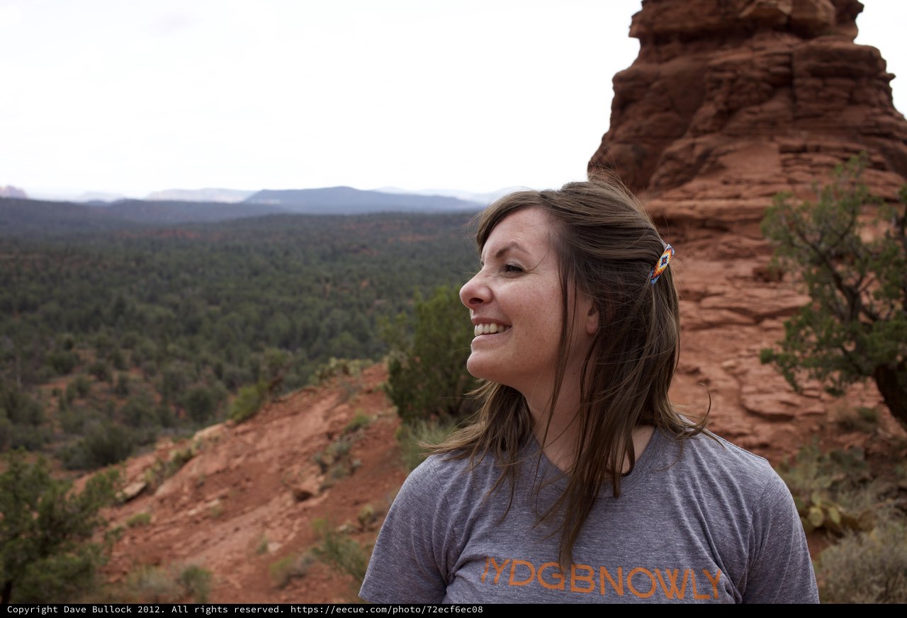 Woman Smiling Atop Red Rock Formation in Sedona