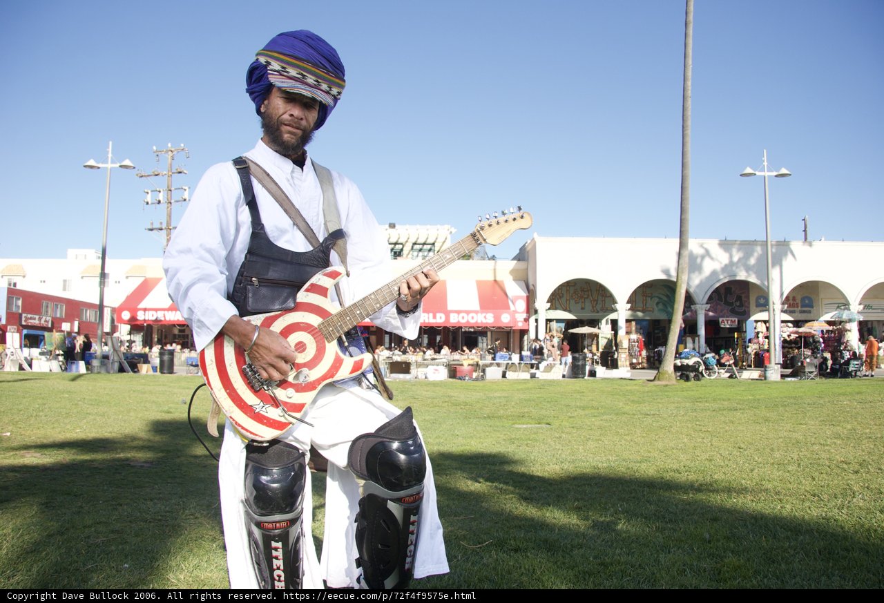 Turbaned guitarist rocking on land