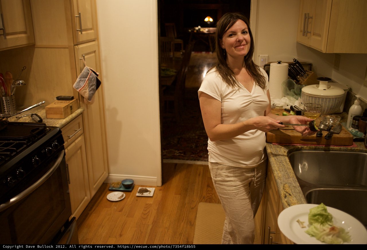 Woman Preparing Food in Warm Kitchen at Night