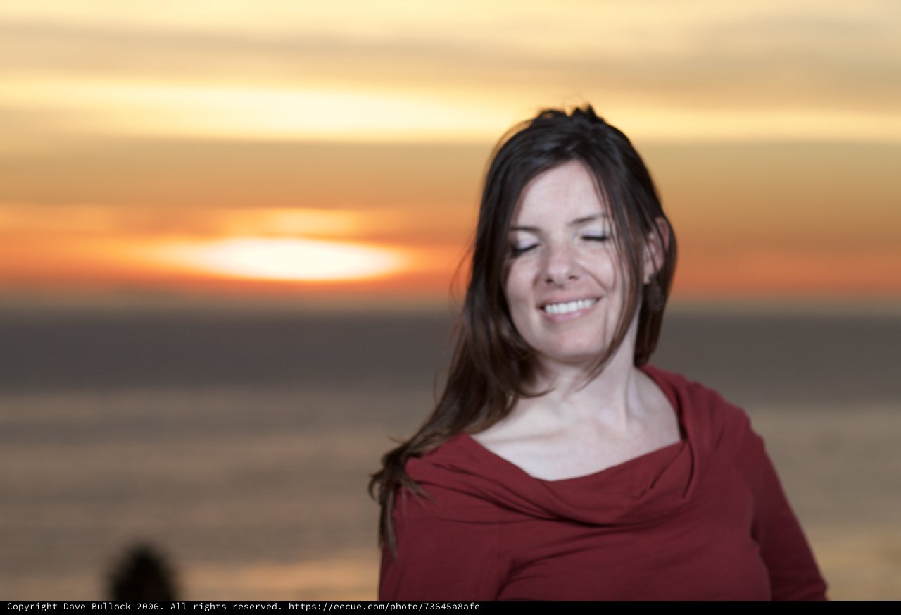 Serene Woman Smiling at Golden Sunset