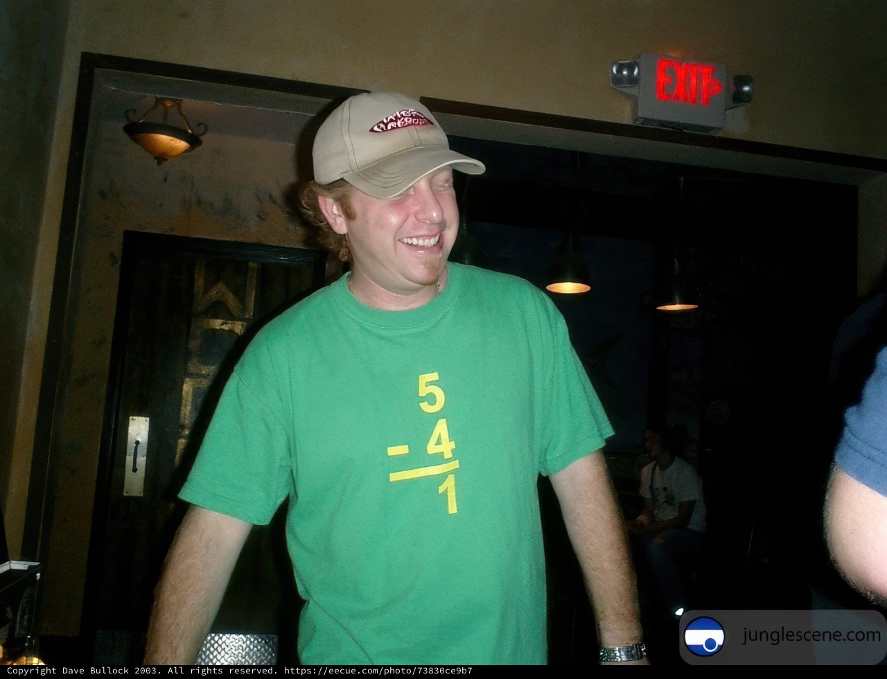 Randy J sporting green T-shirt and baseball cap