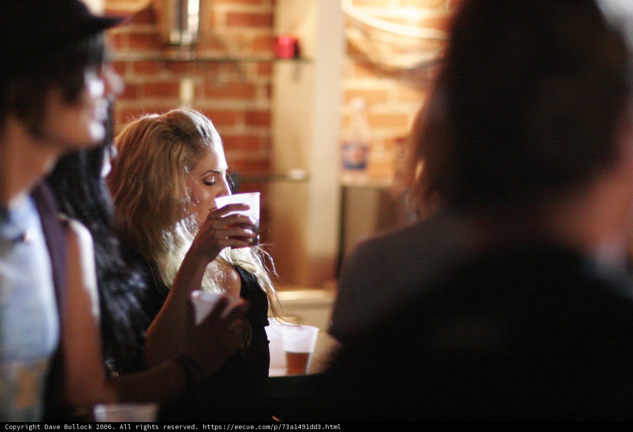 A Woman Enjoying a Beer at a Restaurant