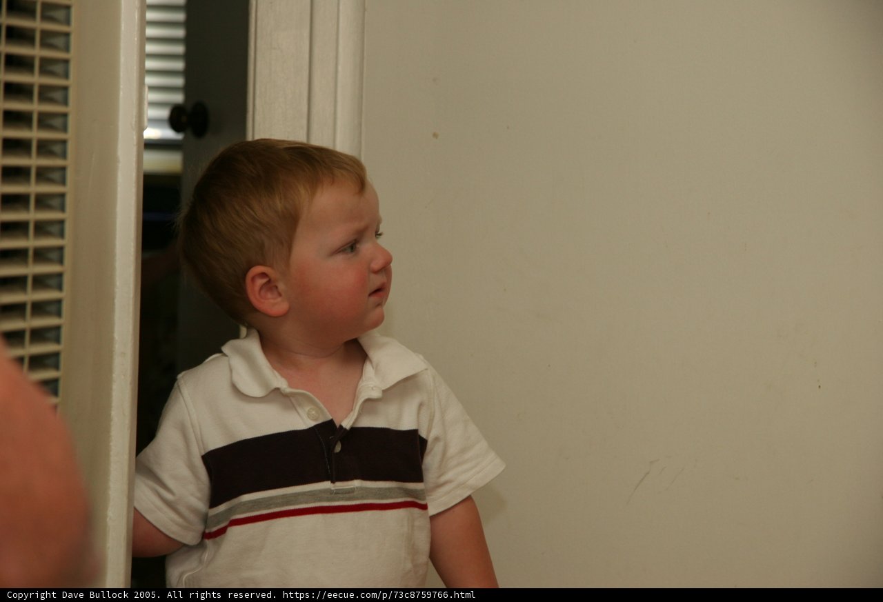 Young Boy at His Home's Doorway
