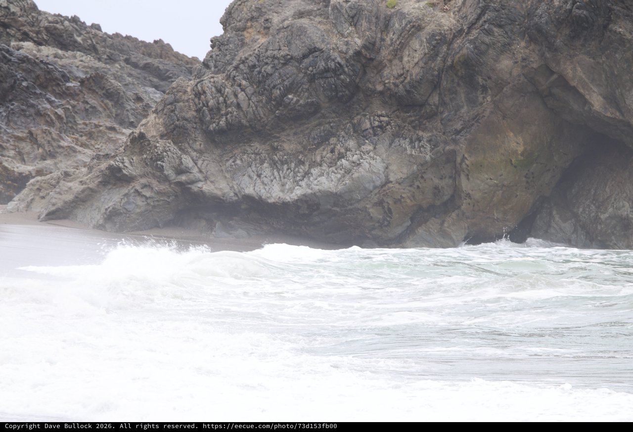 Turbulent Waves Crash Against Rugged Coastal Cliffs