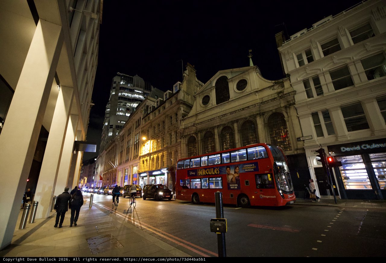 Red Double-Decker Bus on London Street at Night