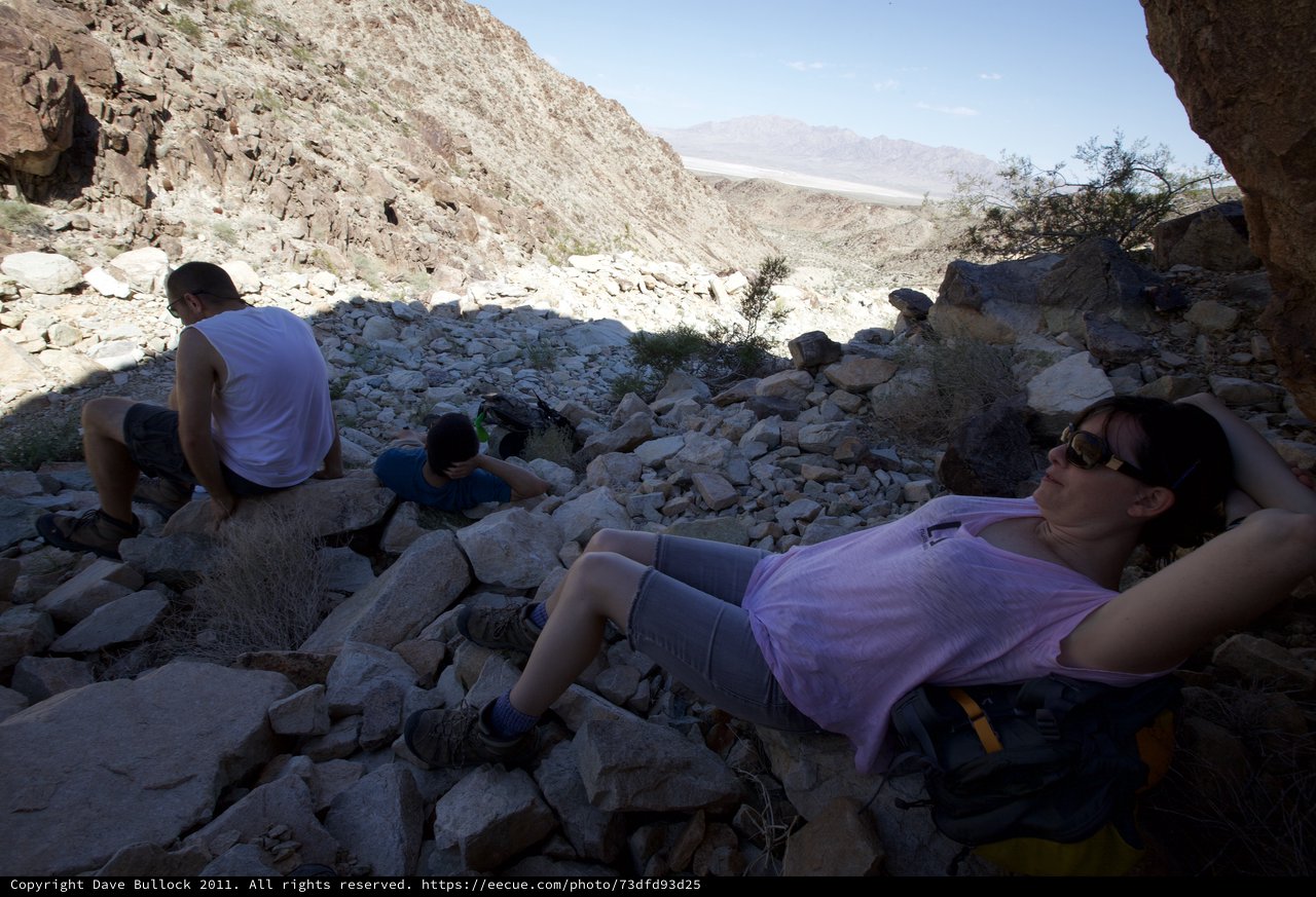 Desert Hikers Resting in Rocky Canyon Shade