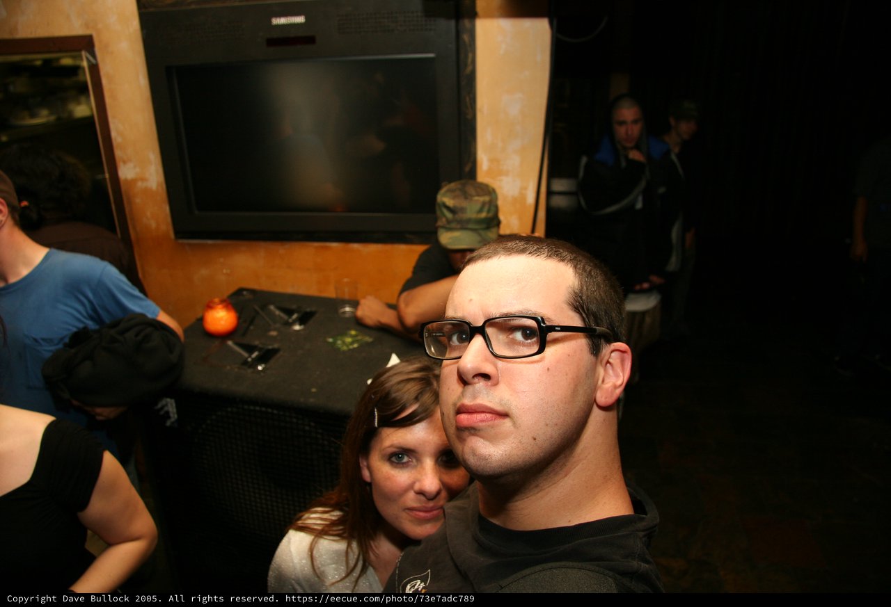 Couple Poses for Selfie at Dimly Lit Bar