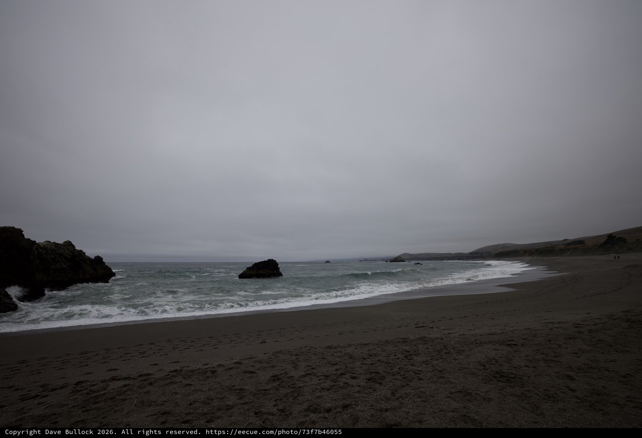 Moody Overcast Beach with Rocky Outcroppings at Dusk