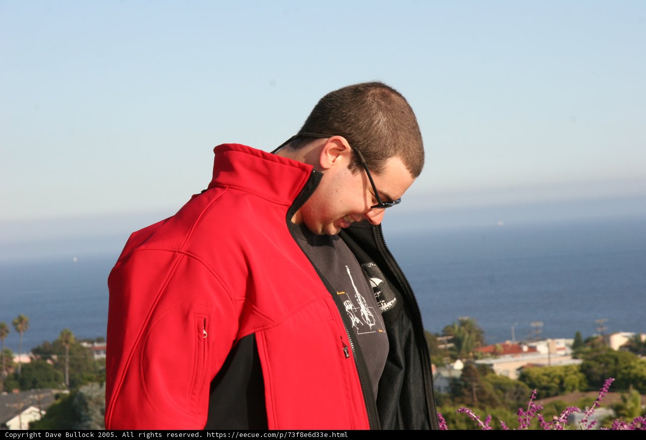 Red Jacket Against the Blue Ocean
