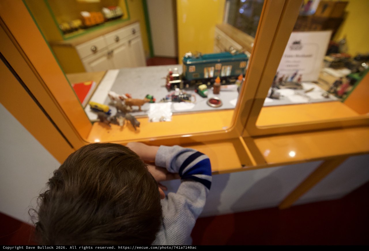 Child Exploring Museum Display Through Glass Case