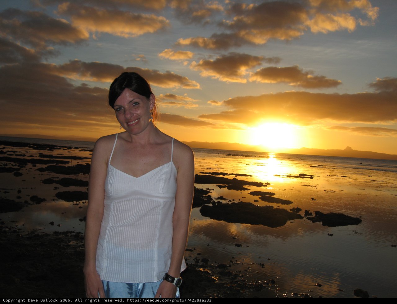 Woman Smiling at Golden Sunset Over Fiji Coast