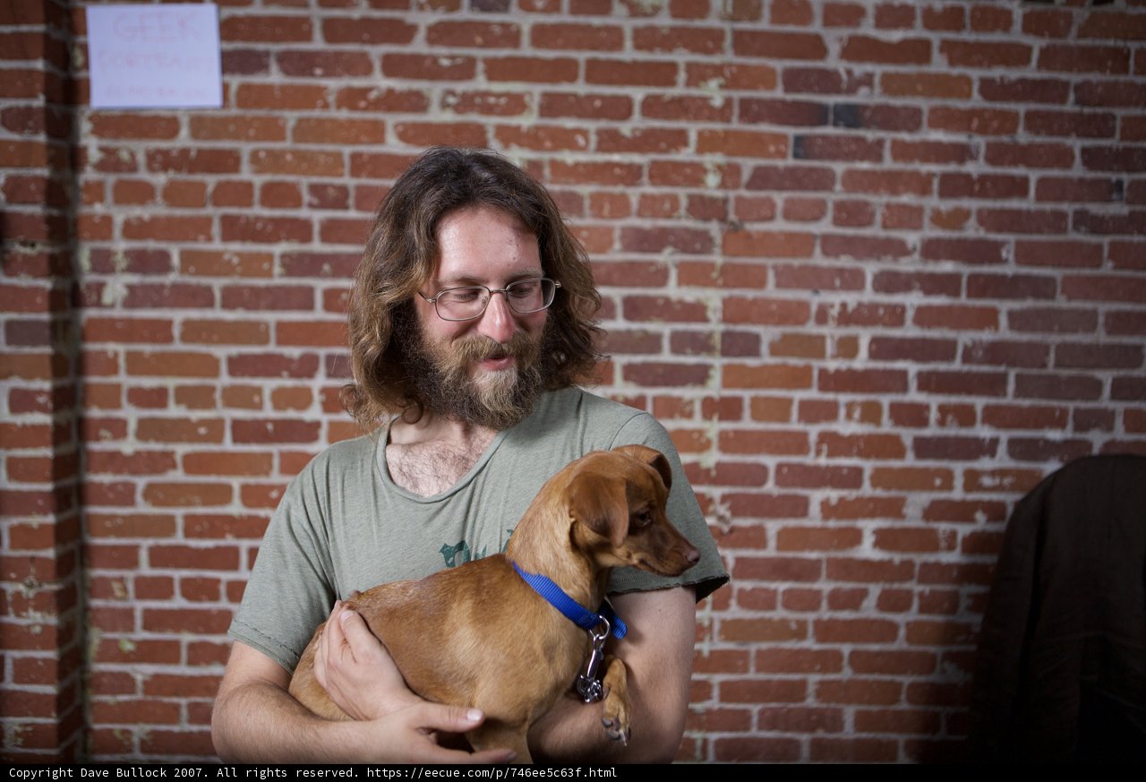 Man and Beagle Pose in Front of Brick Building