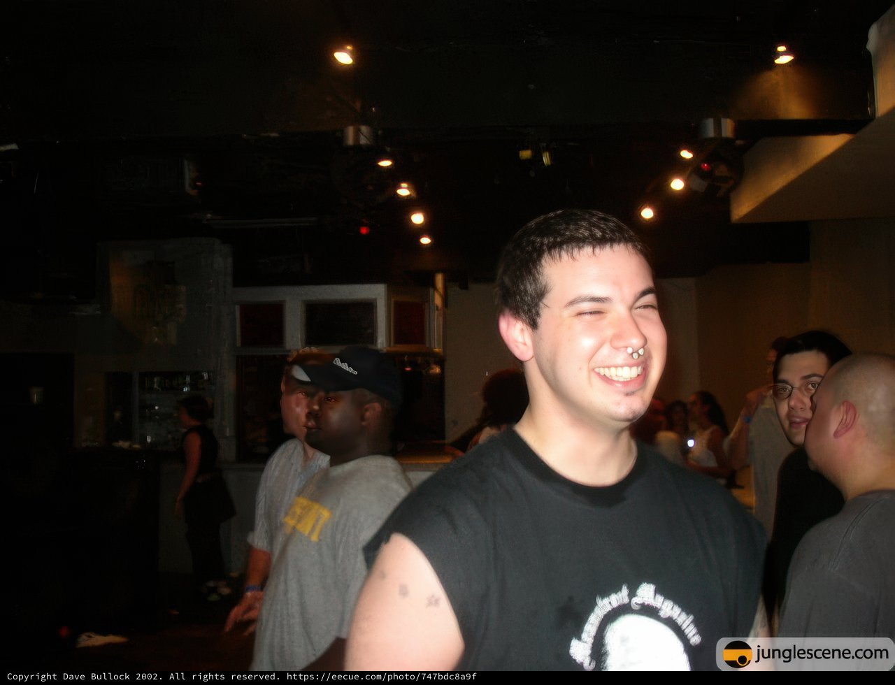 Portrait of Dave B in Black Shirt and Baseball Cap at Night Club