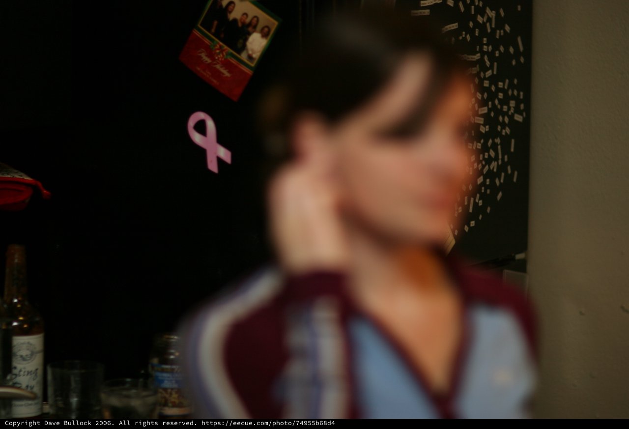Blurred Portrait with Pink Ribbon in Dark Room