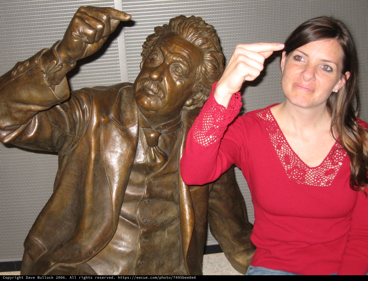 Woman Mimics Einstein Statue's Pointing Gesture