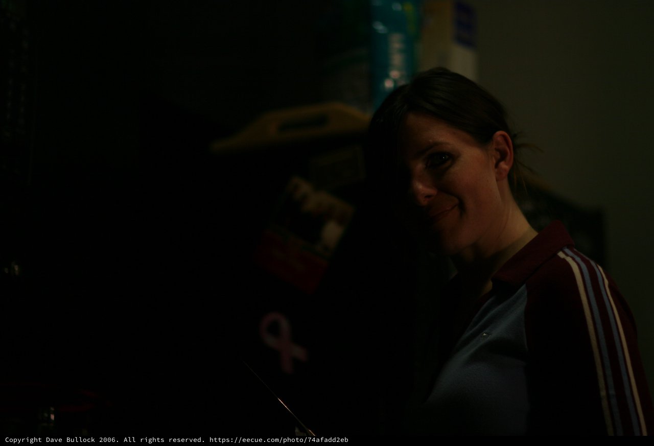 Smiling Woman in Low Light at Night Event