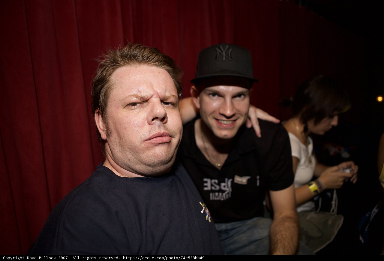 Two Men Strike a Pose at Party