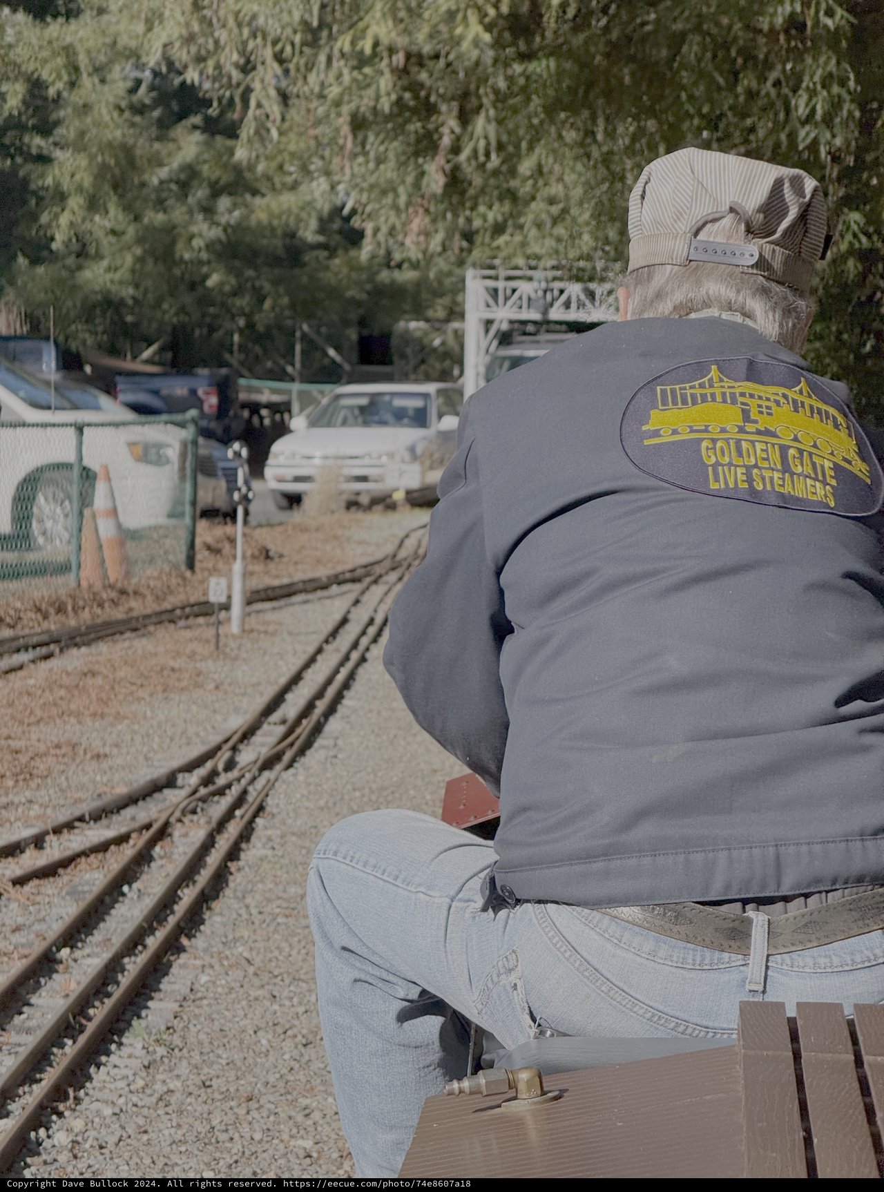 Steam Train Enthusiast Waits by Railway Tracks