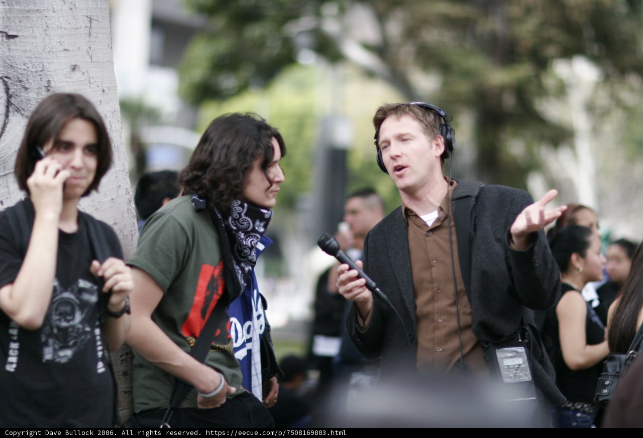 Cell Phone Conversation Among Three Men