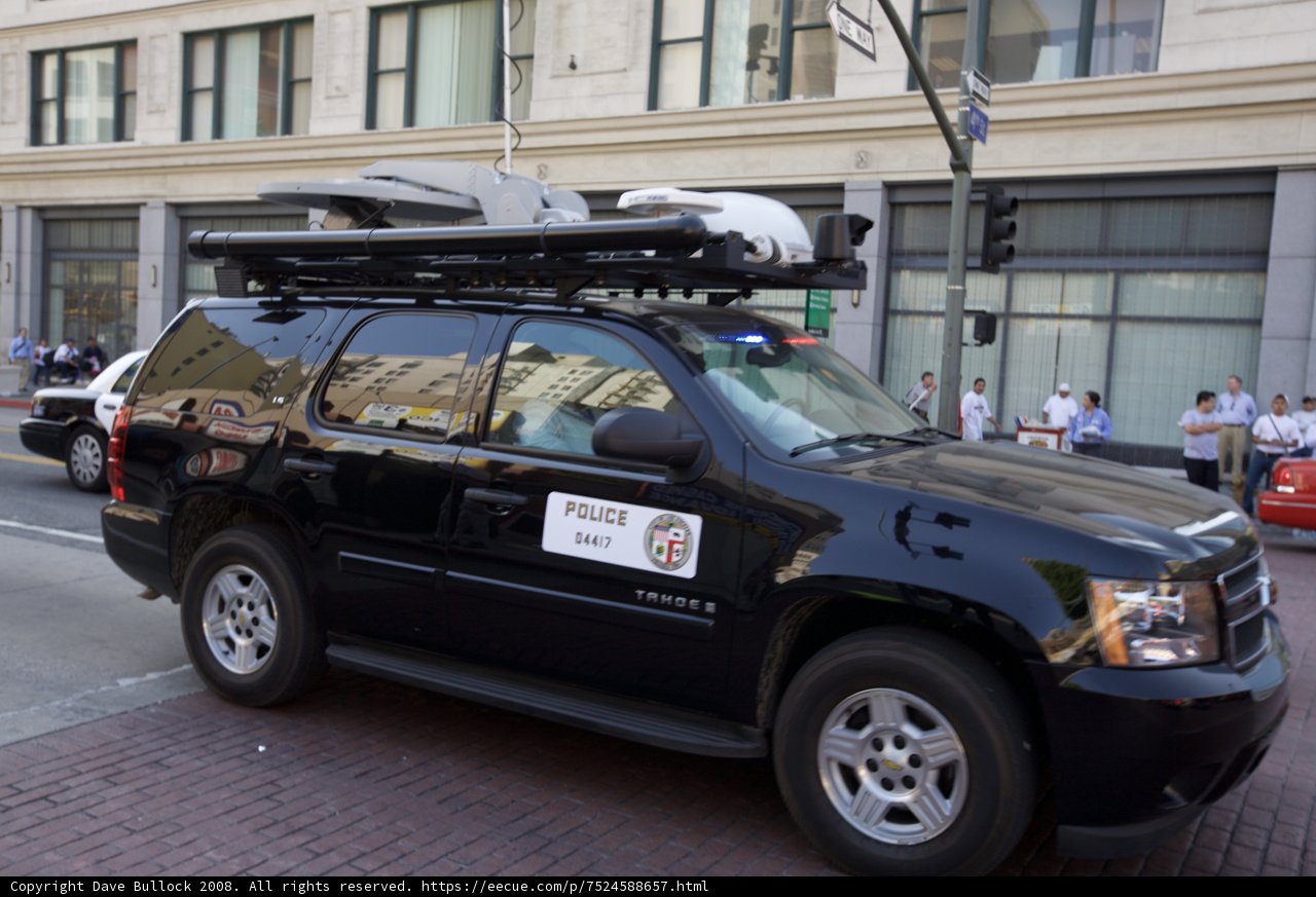 Camera-Equipped Black SUV at Mayday Rally