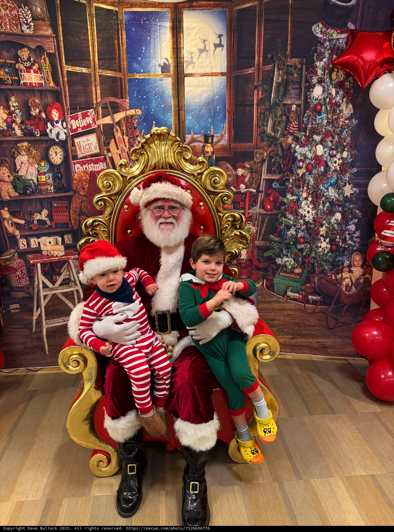 Two Children Visit Santa in His Workshop Grotto