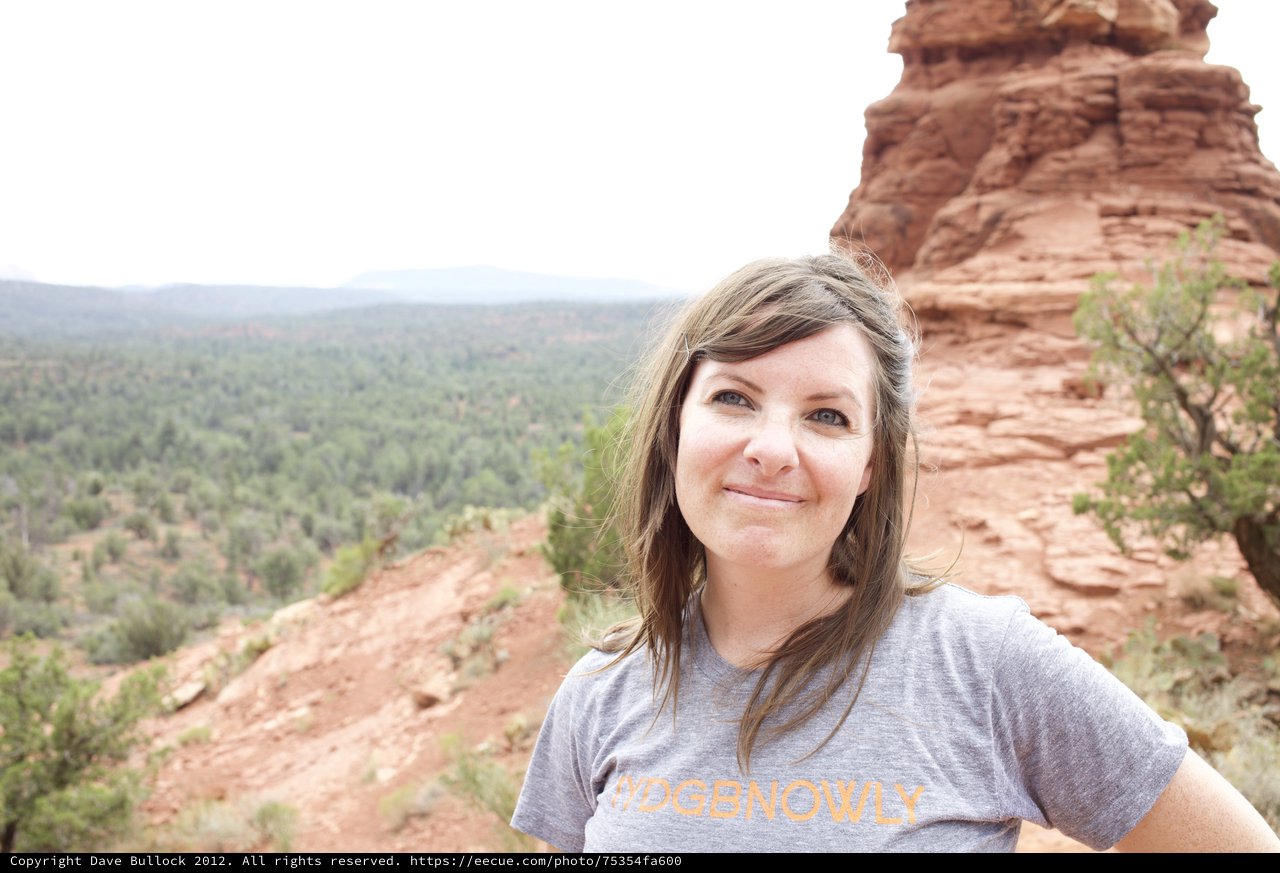 Woman Smiling Beside Red Rock Formation in Sedona
