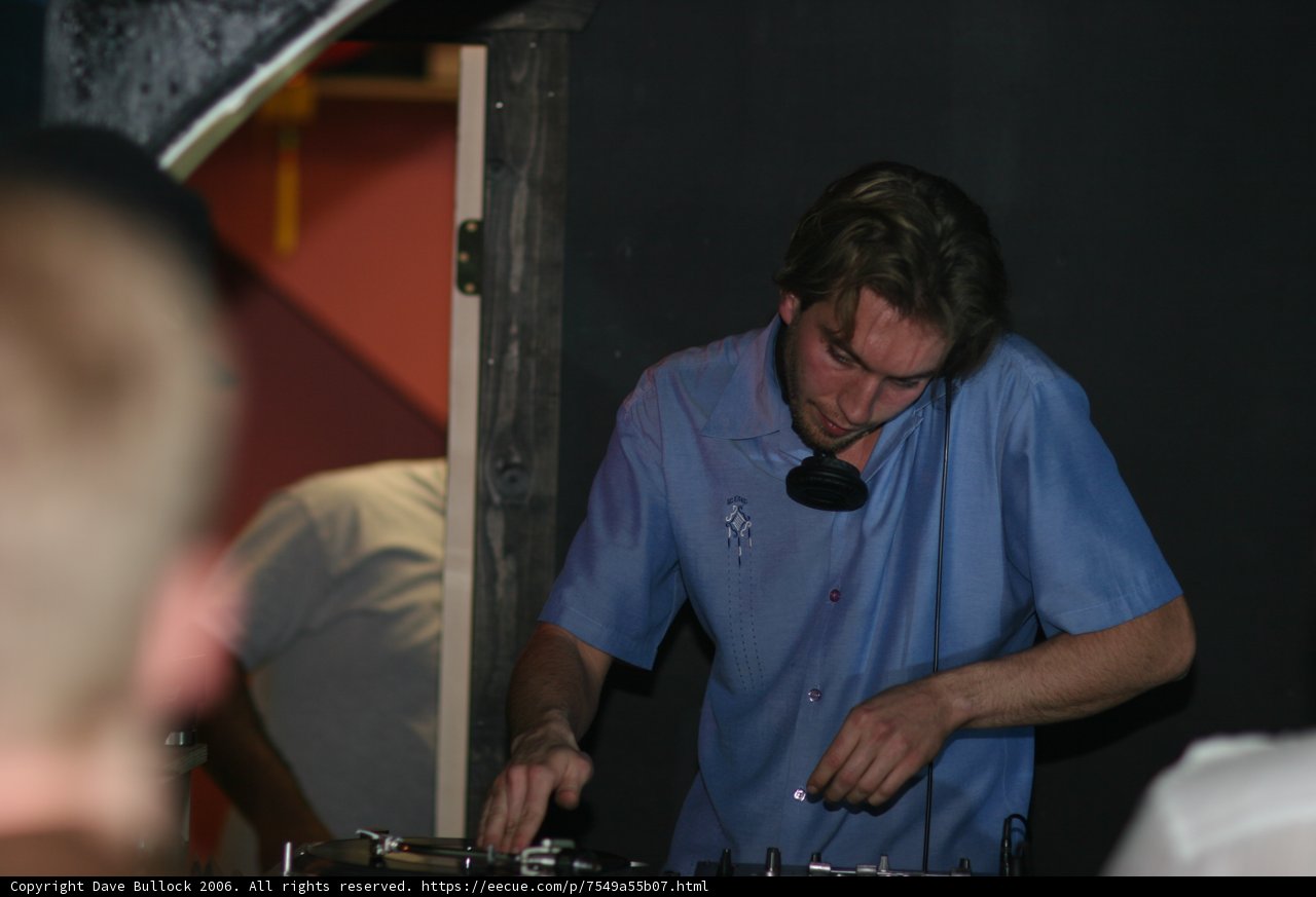 Blue Shirted Deejay Spinning Tracks