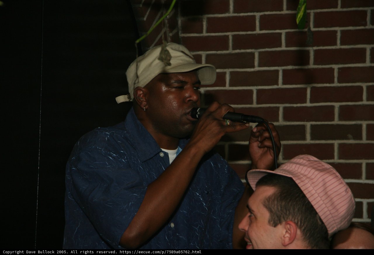 Entertainer Steve J performing with two hats and a microphone