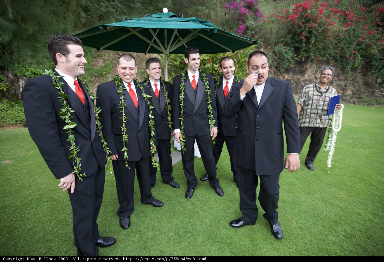 7 Men in Formal Wear Under an Umbrella