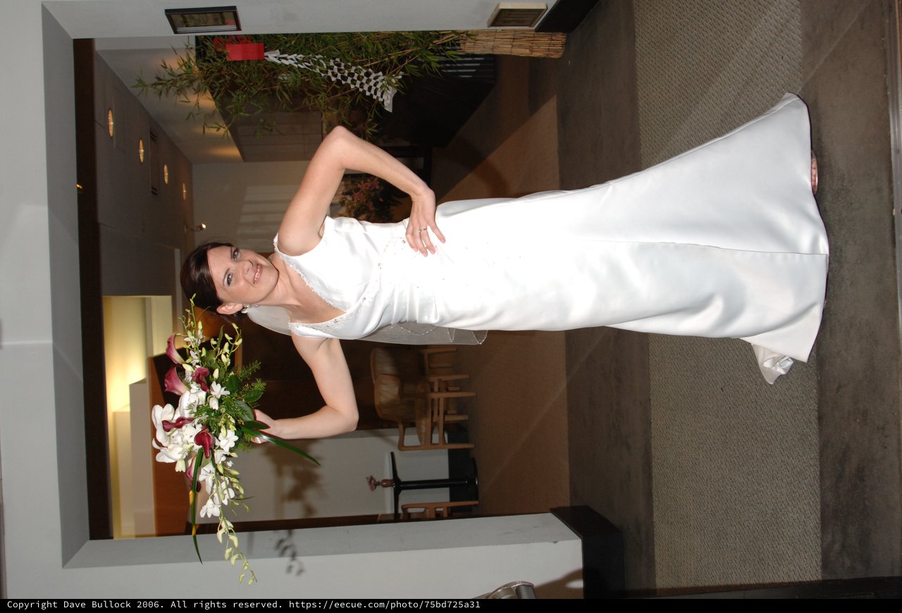Triumphant Bride Raises Bouquet in Wedding Venue