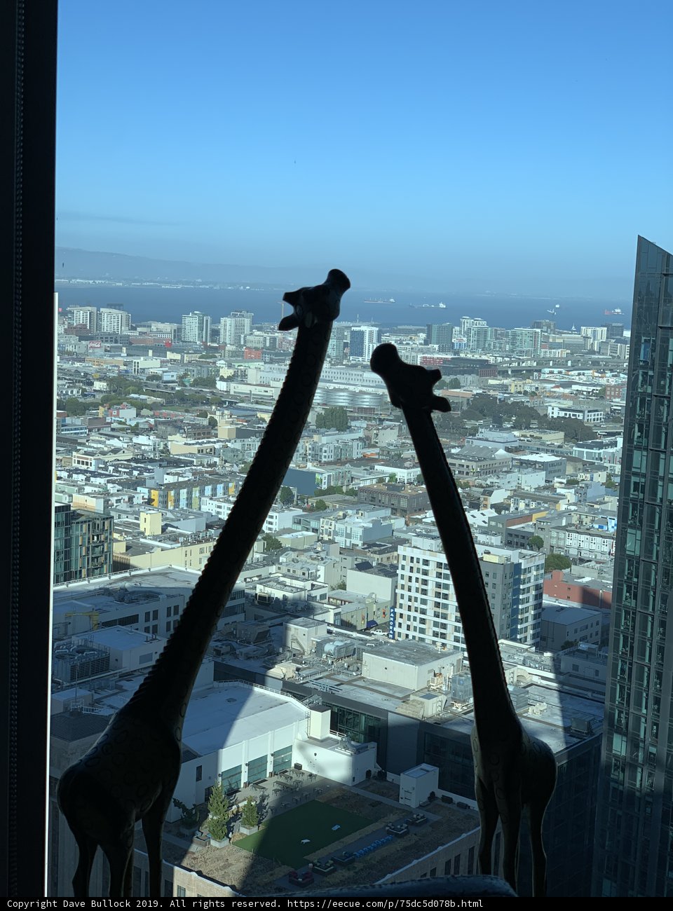 Giraffe Statue Overlooks Metropolis