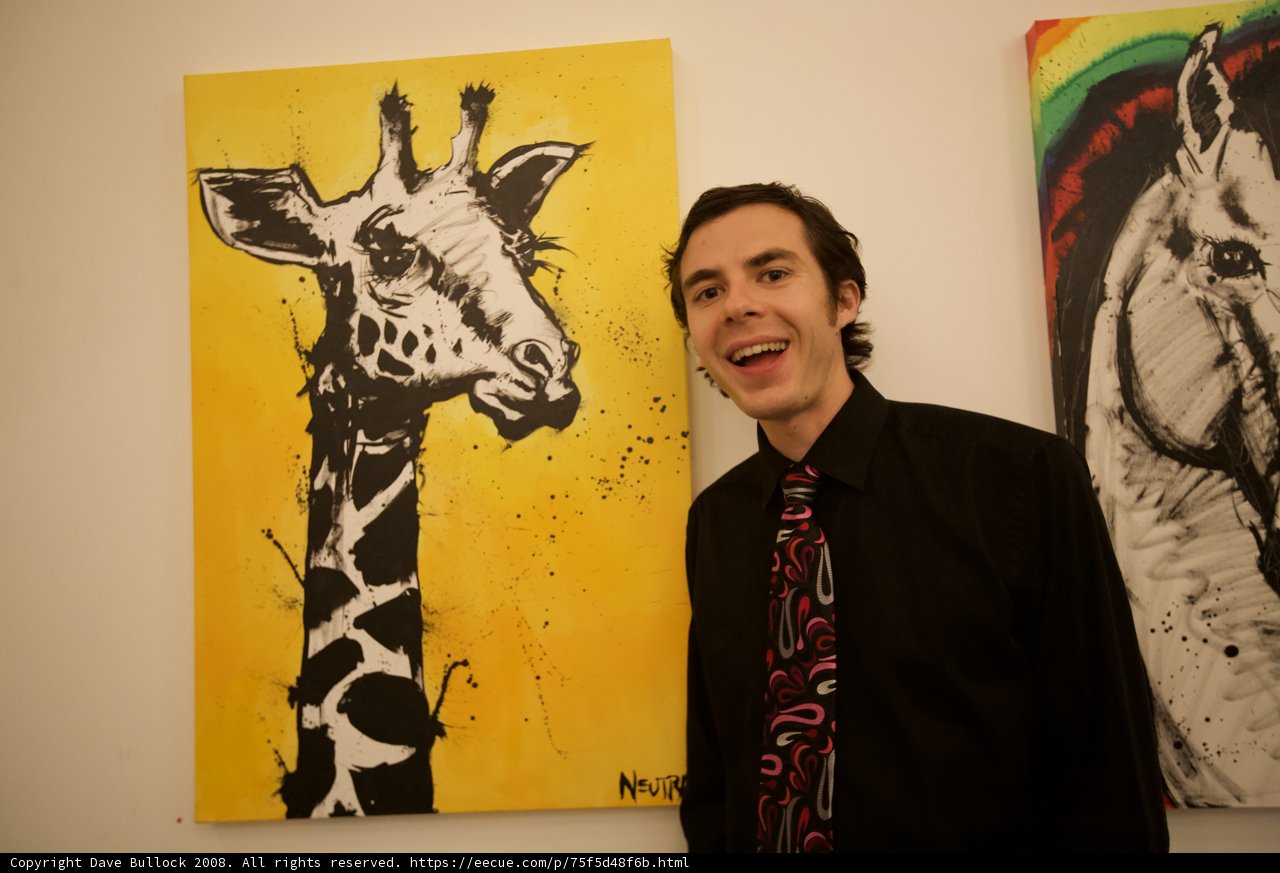 Man in Formal Wear Admires Giraffe Painting