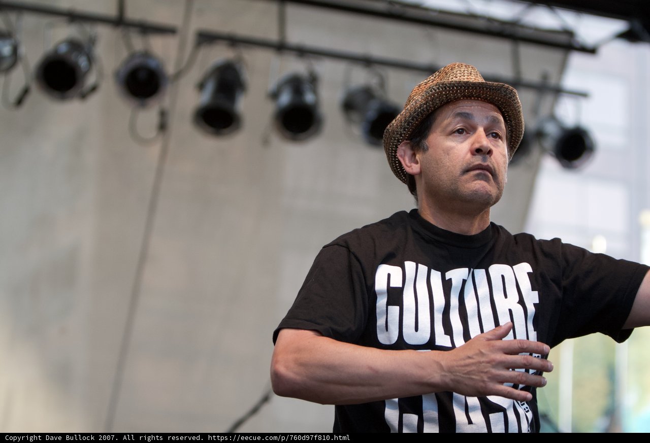 Man in Hat and T-Shirt Performing on Stage